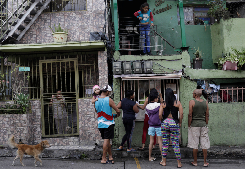 Люди делают ставки на улице в Каракасе, Венесуэла. Фото: Ricardo Moraes / Reuters
